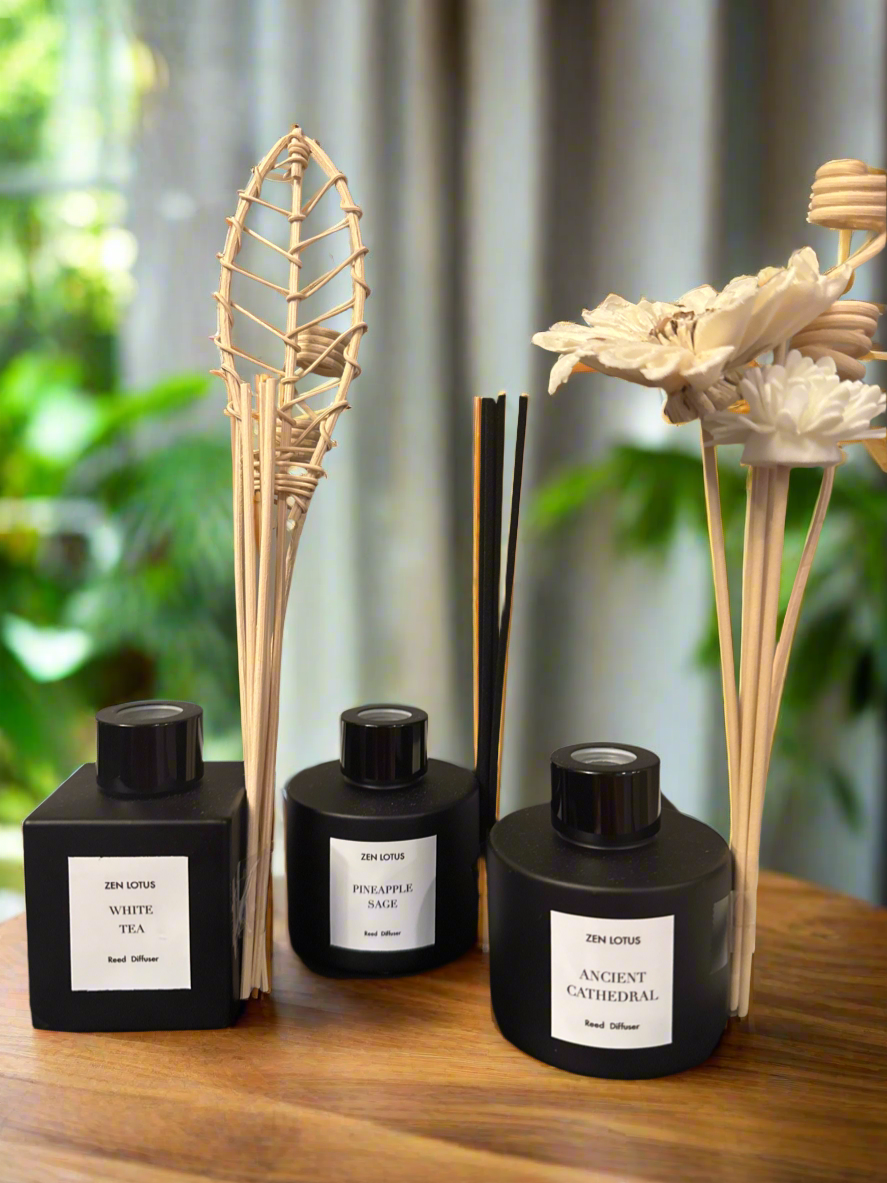 Set of diffusers with reeds and decorative elements on a wooden surface