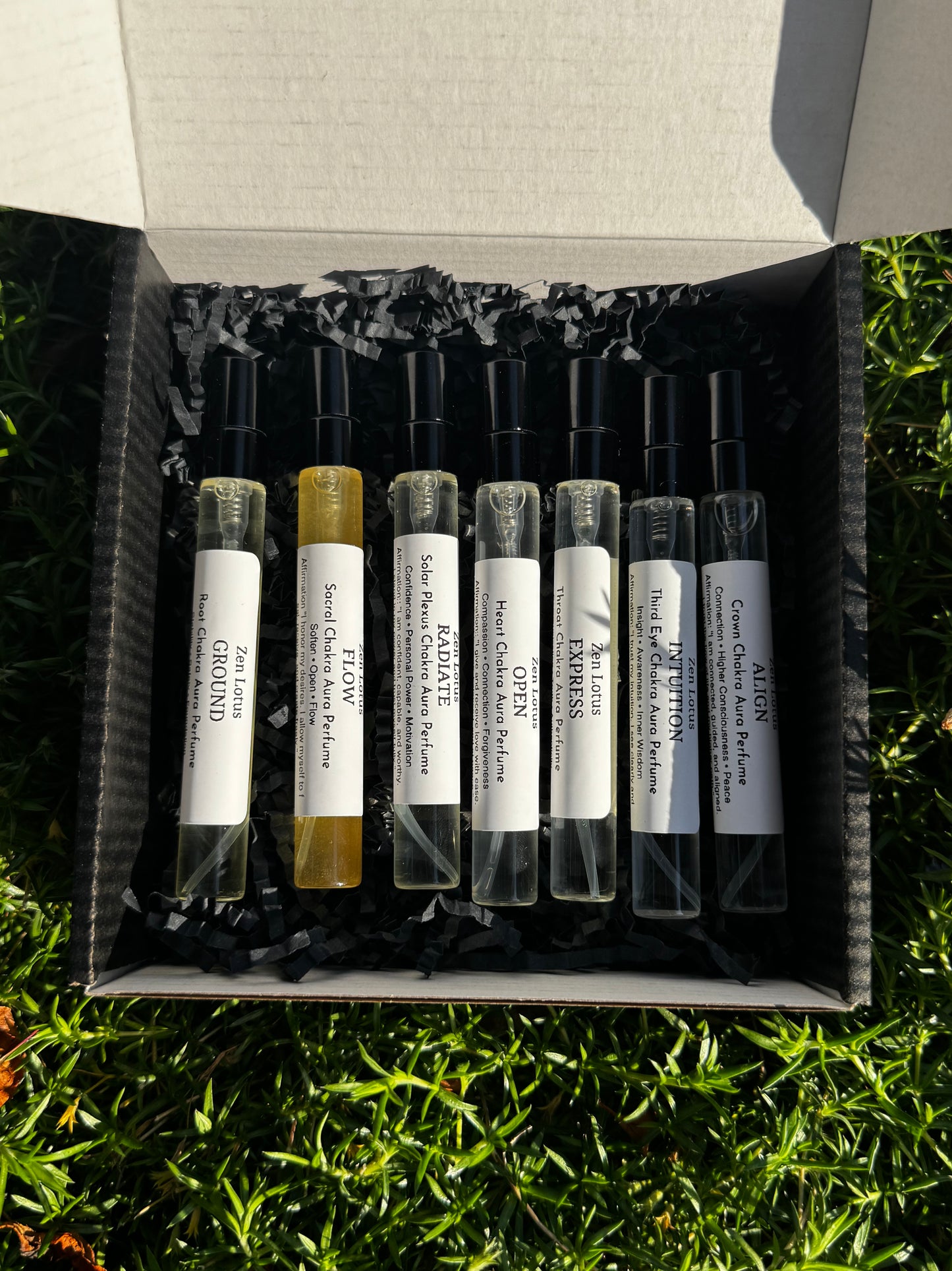 Set of small glass vials with labels in a box on grass